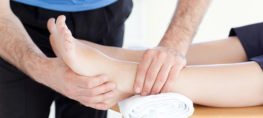 Photo of a physiotherapist assessing a patient's top of foot pain