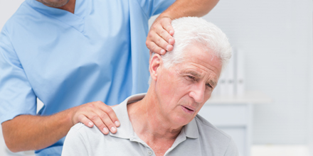 photograph of an older man receiving physiotherapy