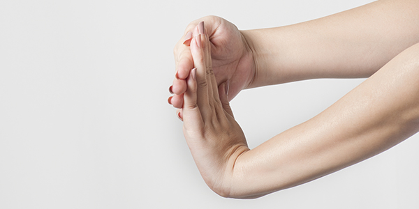 photograph of hands stretching to improve trigger finger
