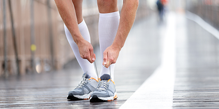 picture of of a runner wearing compression stockings to improve performance