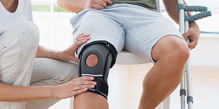 photograph of a of a man getting fit with a custom knee brace